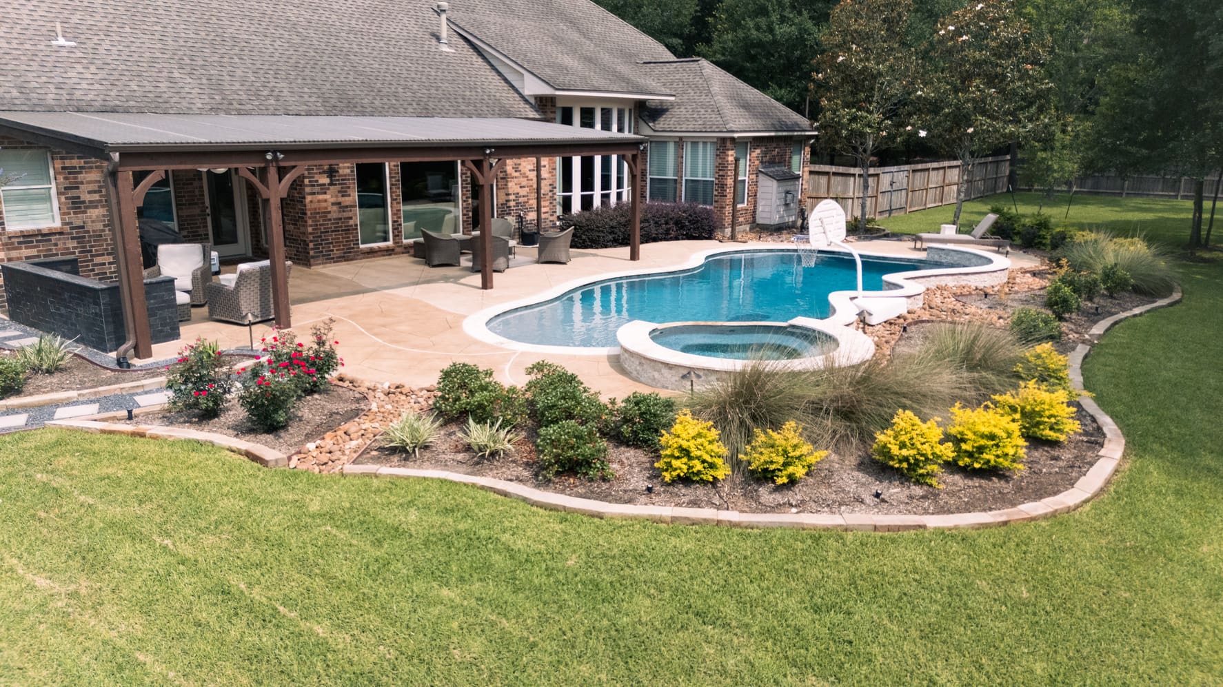 Aerial drone view of a completed Theiss landscape and paver hardscape project in Cypress, TX